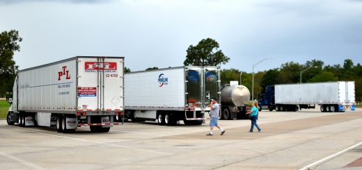 Truck Driver walking to truck at highway rest-stop, truck parking