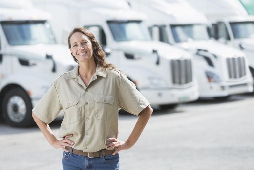 Woman standing in front of semi-trucks