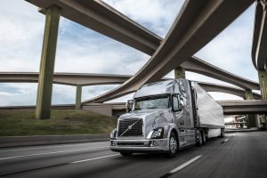 Volvo Truck on highway under roadyways as Volvo Electric Trucks Funding accelerates the transition to zero-emission vehicles, supporting a sustainable future in heavy-duty transportation.