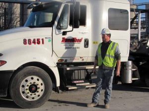 TransWood truck with its driver, representing the company's commitment to quality and service