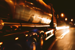 Close-up of the side of the tanker on road at night